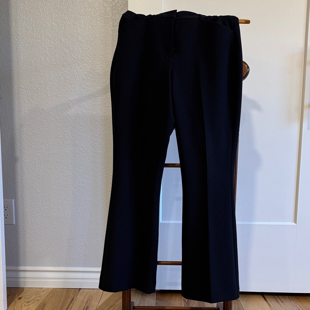 Mid-waist Editor pant w/hook closure, slant hand & back pockets flare leg.